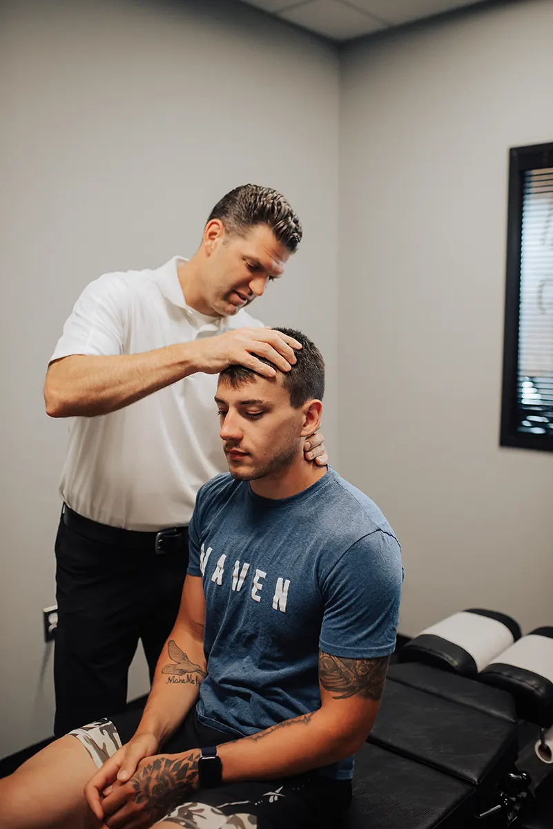 Dr. Justin Berlin Performing Adjustment For Neck Pain at Delta Chiropractic in Rochester Hills, MI.