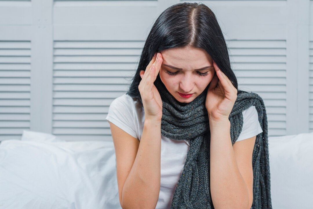 Woman experiencing headache and neck discomfort